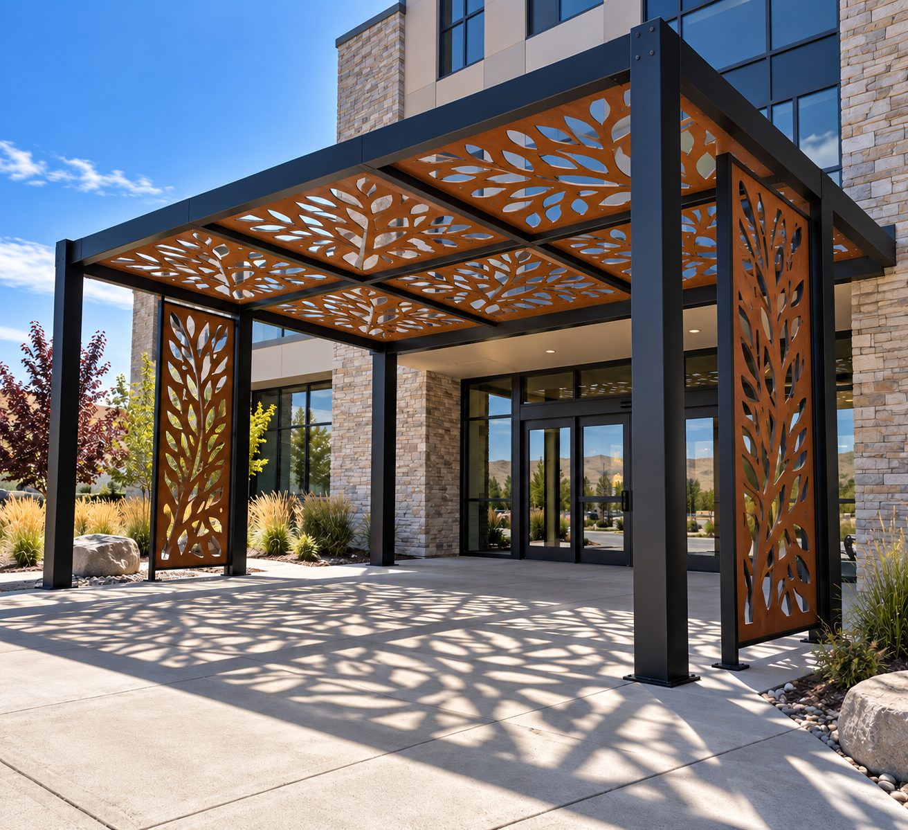 Entry canopy in Corten weathering steel with laser-cut foliage panels over a commercial building entrance